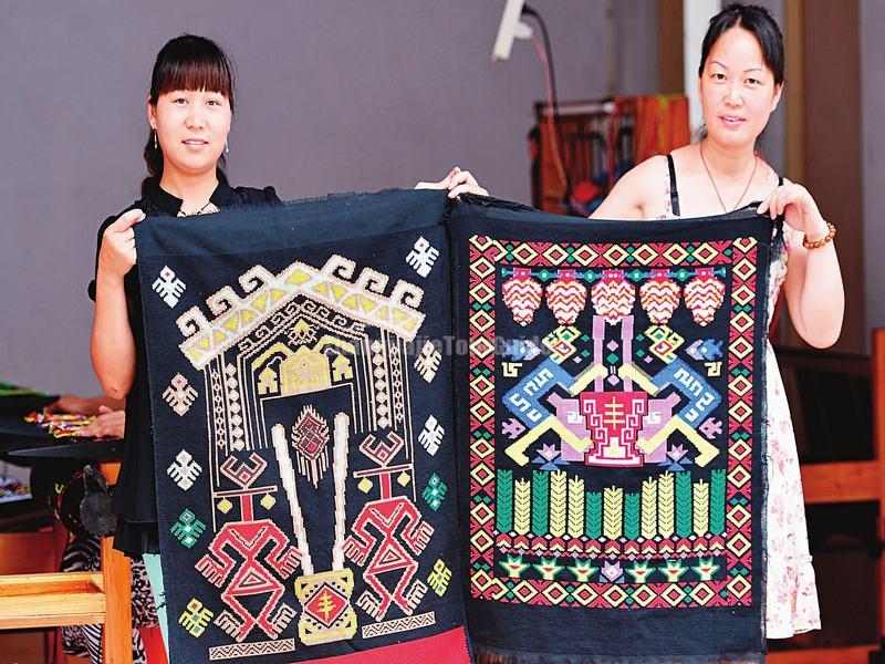 Two Women Show Their Xilankapu Brocade